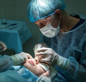 doctor conducting operation at patient in operating room